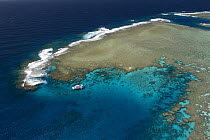 Aerial view of the Great Barrier Reef with tourist dive boat. Agincourt Reefs, off Port Douglas, Queensland