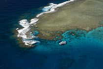 Aerial view of the Great Barrier Reef with tourist dive boat. Agincourt Reefs, off Port Douglas, Queensland