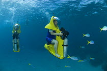 Tourists on Scubadoos from the Great Adventures Pontoon watching fish. Great Barrier Reef, Queensland, Australia 2006