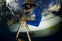 Scientists on the Undersea Explorer research vessel testing a coconut rattle to attract sharks. Queensland, Australia
