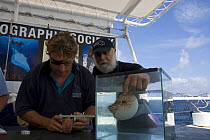 Scientists on the Undersea Explorer research vessel with a Nautilus. Queensland, Australia