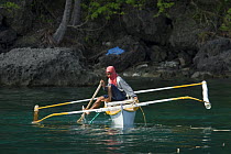 Aquarium trade fishermen on huka. Paint compressor supplies air to the fishermen who can stay underwater long to catch ornamental fish. Verde Island, Mindoro, Philippines