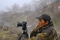 Photographer Igor Shpilenok taking photos after landslide in the Valley of the Geysers, Kamchatka, Russia, 3 June, 2007
