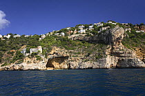 Coastal landscape with clifftop houses and caves, Javea, Alicante, Spain