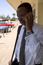 Gambian businessman using mobile phone, Gambia, 2007