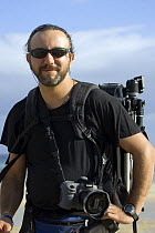 Photographer Fabio Liverani with camera and tripod, on location on Fuerteventura Island, Canaries, 2007