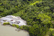 Trucks coming from either Coca or Lago Agrio cross the Napo river by barge before travelling on to various oil company instalations in the Yasuni National Park, Amazonia, Ecuador