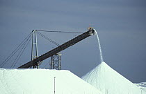 Pyramids of salt at the Leslie Salt Company's operations. Over 2 million tonnes of solar produced salt are exported out of the area each year. Port Hedland, West Australia