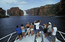 Tourists view the King George Falls from a boat, King George River, Kimberley, Western Australia