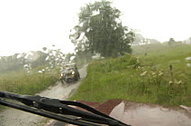 View through car windscreen during downpour, country lane, Yorkshire, England
