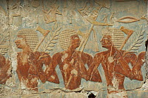 Carvings of men wielding axes on the Habu Temple, Luxor, Egypt, 2001