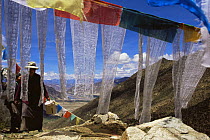 Prayer Flags and people at the Xiongse nunnery, Tibet  2007