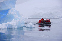 Tourists in zodiac boat viewing icebergs. Antarctica.