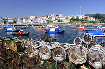 Crab / Lobster pots piled up on the harbourside in Finisterre fishing port Costa da Morte, Galicia, Spain
