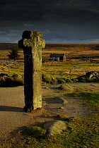 Nun's Cross, with Nun's Cross Farm behind, stormy sky, Dartmoor NP, Devon, UK.