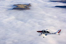 Small Aeroplane flying above clouds at an airfied on the Farrenberg, Baden-Wuerttemberg, Germany