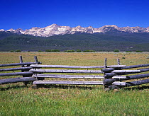 Fence with Sawtooth Mountains behind, Sawtooth NRA, Idaho, USA