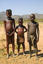 Young Himba children in Kaokoland, Namibia. Himba girls are identified by two distinctive plaits, whilst Boys have a "Mohican".