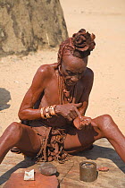 Woman of the Himba tribe, Kaokoland, wearing distinctive headdress and clothing. Namibia 2007