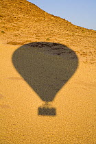 The shadow of a hot air balloon during a flight over the Sossuvlei sand dunes, Namibia