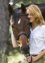 Woman with Bay Appendix Quarter horse gelding, Castle Rock, Colorado, USA, model released