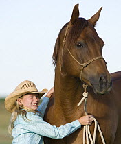 Young girl with sorrel Quarter Horse gelding, Longmont, Colorado, USA, model released