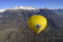 Hot air balloon in flight over the Aosta Valley, northern Italian Alps