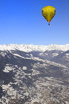 Hot air balloon in flight over the Aosta Valley, northern Italian Alps