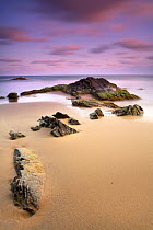 Rocks in the sand, Playa (beach) de los Negretes, Calblanque, La Manga, Murcia, Spain
