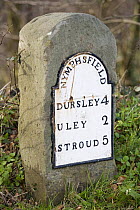 An old iron milestone at Nymphsfield on the Cotswold Way, Nymphsfield, Gloucestershire, UK
