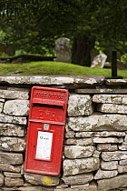 Traditional red Postbox in dry stonewall of churchyard at Capel y Ffin, Vale of Ewyas, Brecon Beacons National Park, Powys, Wales