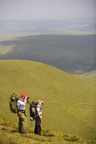 Walkers admiring the view at Llyn y Fan Fach, Brecon Beacons National Park, Powys, Wales