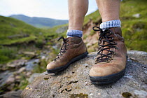 Close-up of hiker's boots at Llyn y Fan Fach, Brecon Beacons National Park, Powys, Wales