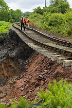 Two men inspect a landslip under railway at Highley on the Severn Valley Railway due to torrential rain, June 2007