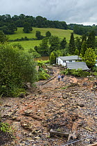 Two people inspect a landslip under railway at Highley on the Severn Valley Railway due to torrential rain, June 2007