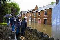 People watching flood waters along a residential street in Stroud, Gloucestershire, July 2007