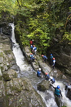 Gorge-walkers at Craig Y Ddinas waterfalls, Brecon Beacons National Park, Powys, Wales
