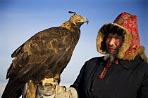 Kazakh hunter with Golden eagle (Aquila chrysaetos) Xinjiang Province, North-west China. February 2007, BBC "Wild China" series