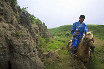 Mongolian rider on his horse at Xanadu, Inner Mongolia, Northern China. July 2006, BBC "Wild China" series