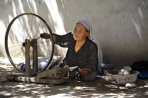 Woman silk spinning at Hotan (Hetian), a town along the ancient Silk Road. Xinjiang Province, North-west China. July 2006, BBC ^Wild China^ series