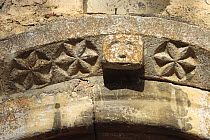 Stone carving detail above the door on the Romanesque hermitage of St Martí, Escalarre, in the the Pyrenees mountains. Catalonia, Lerida, Spain