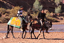 Two Young men riding beside a river in Ait Benhaddou, Morocco December 2007