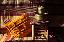 Pot, stool and cushion inside of haima in Erg Lihoudi desert, MHamid, Morocco December 2007