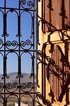 Detail of window grate with the landscape behind. Kasbah of Taourirt, Ouarzazate, Morocco December 2007