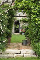 Watering can and archways in Roquelin Gardens. Meung sur Loire, Loiret, France
