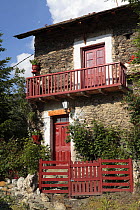 House with red doors and balconies. Alendo in the Pyrenees mountains, Catalonia, Lerida, Spain
