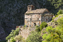 Romanic hermitage clinging to the hillsides of Arboló in the Pyrenees mountains. Catalonia, Lerida, Spain
