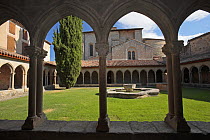 Archways and courtyard of the Abbey of St Hilaire, France
