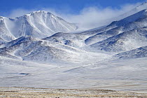 Clouds swirl around the snow-covered peaks of Tibet's Chang Tang Nature Reserve. As the second largest Nature Reserve on earth, it is China's greatest natural asset. December 2006