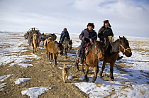 A Kazakh family following ancient migration routes, bringing their possessions and livestock down from the Altai mountains of Xinjiang Province, north-west China. February 2007